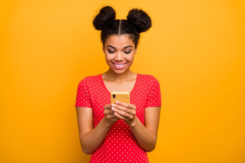 lady smiling with phone in hands
