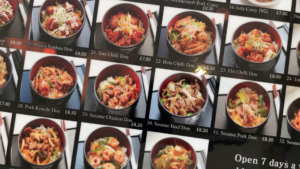 A close up shot of the Pompoko Brighton Menu with various pictures and titles of dishes